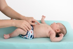 baby crawling on hands and knees wearing cloth diaper